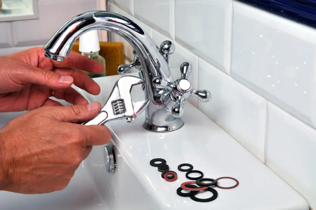 Plumber performing maintenance on a bathroom faucet in Firestone