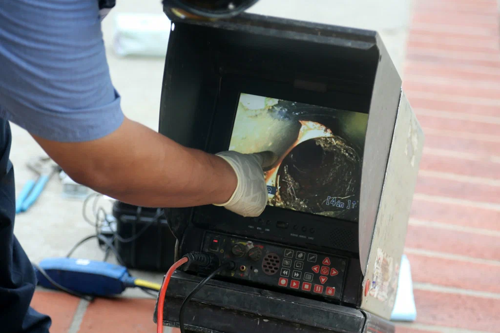 Technician viewing a drain inspection camera in Firestone