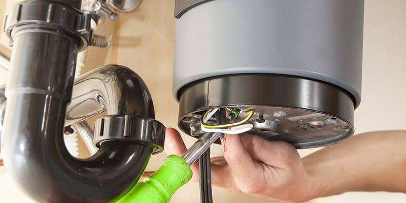 Technician repairing the heating element of a water heater in Firestone